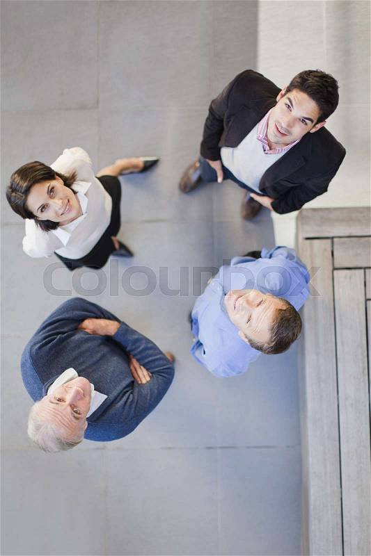 Overhead view of business people talking, stock photo