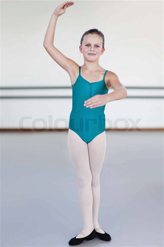 Ballet dancer standing in studio, stock photo