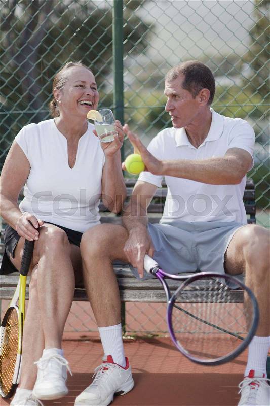 Older people having lemonade outdoors, stock photo