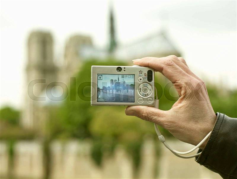 Older person taking picture of cathedral, stock photo