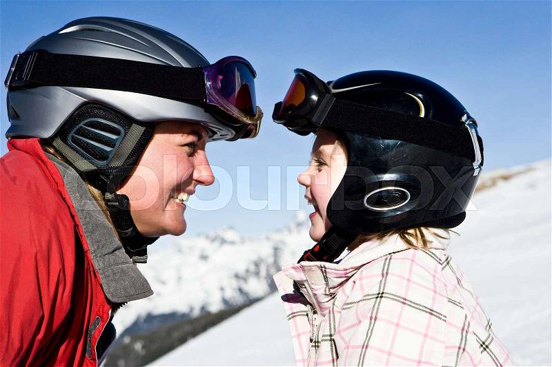 Mother smiling at daughter, stock photo