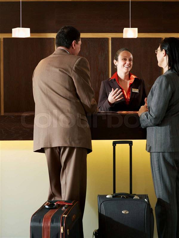 Hotel receptionist talking, stock photo