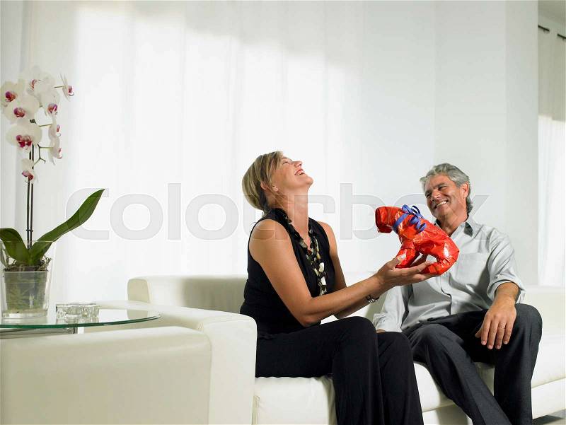A woman laughing at a gift, stock photo