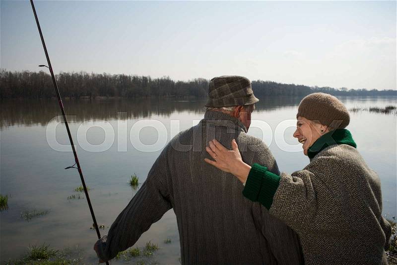 Senior couple man holding fishing rod, stock photo