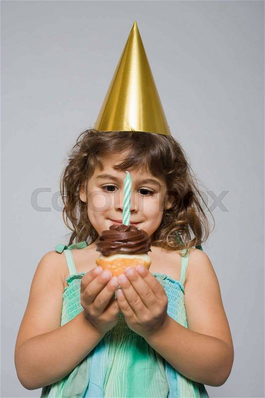 Girl with birthday cupcake, stock photo