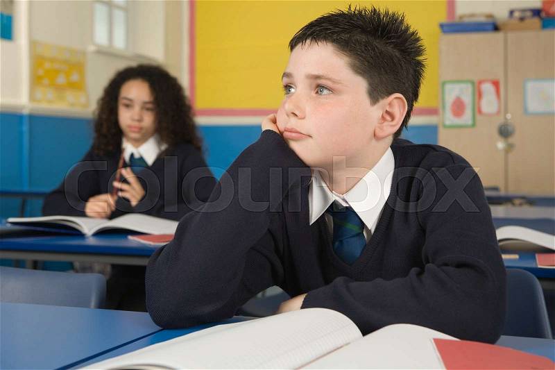 Bored students in classroom, stock photo