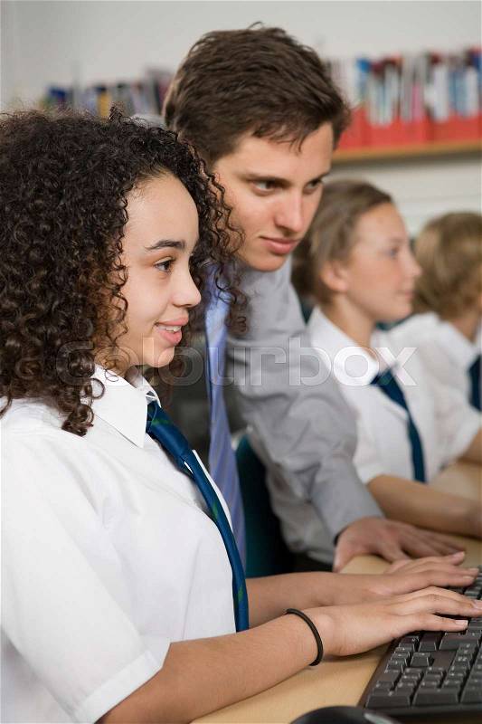 Teacher and girl with computer, stock photo