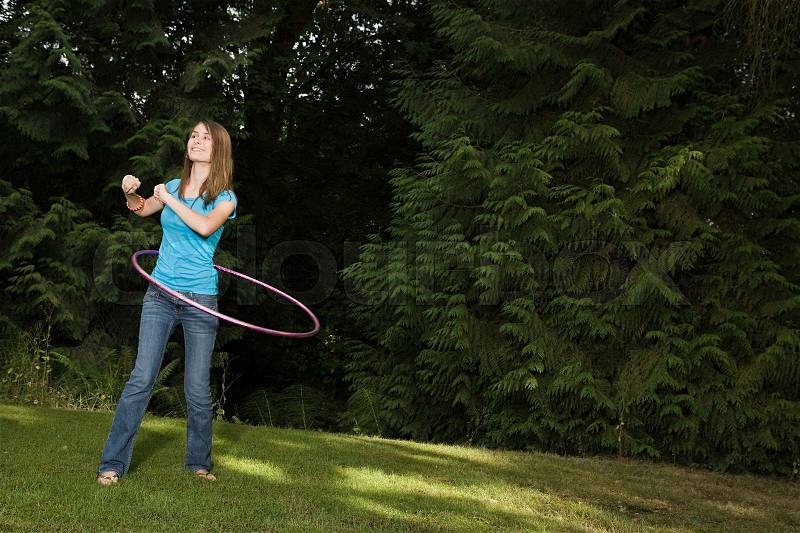 Teenage girl with plastic hoop, stock photo