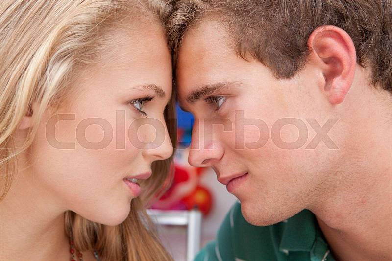 Teenage couple face to face, stock photo