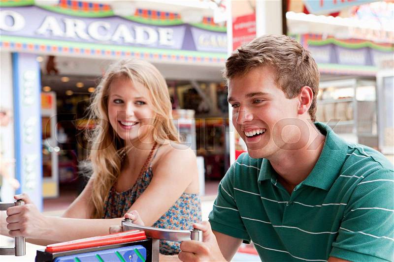Teenage couple at shooting gallery, stock photo
