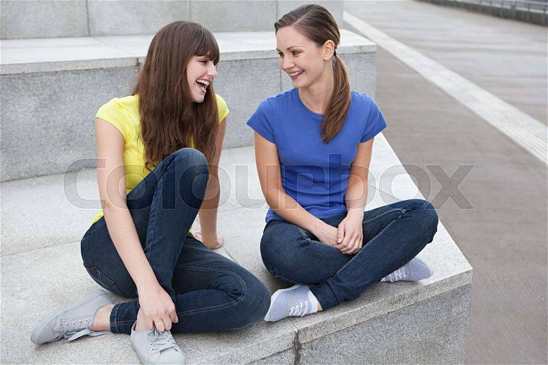 Girlfriends laughing, stock photo