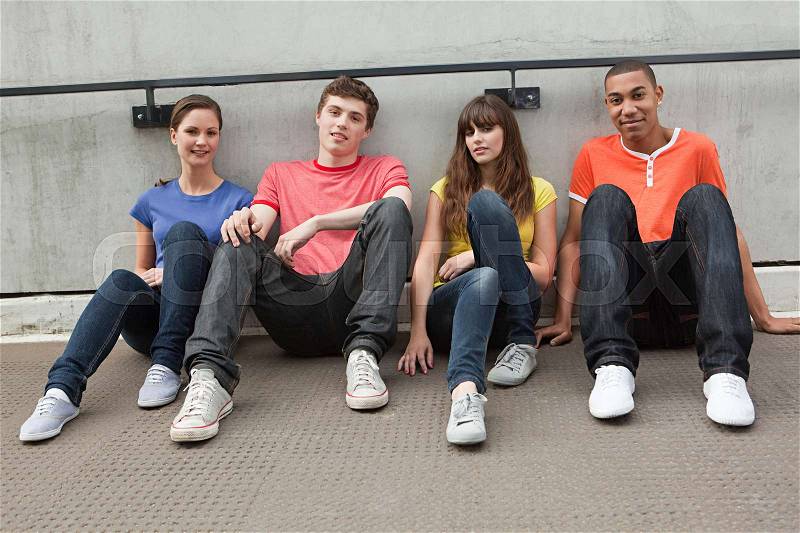 Young people sitting in row, stock photo