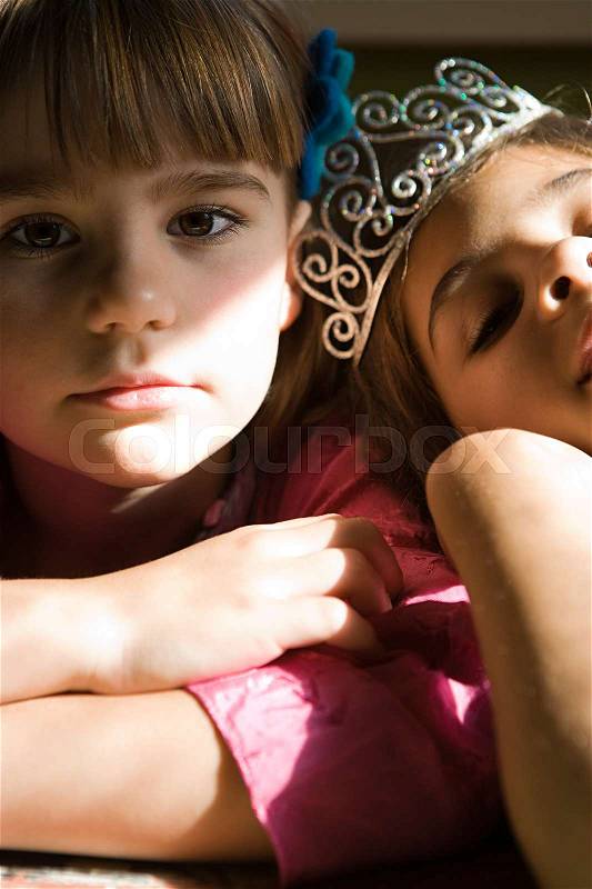 Two girls, one wearing tiara, stock photo