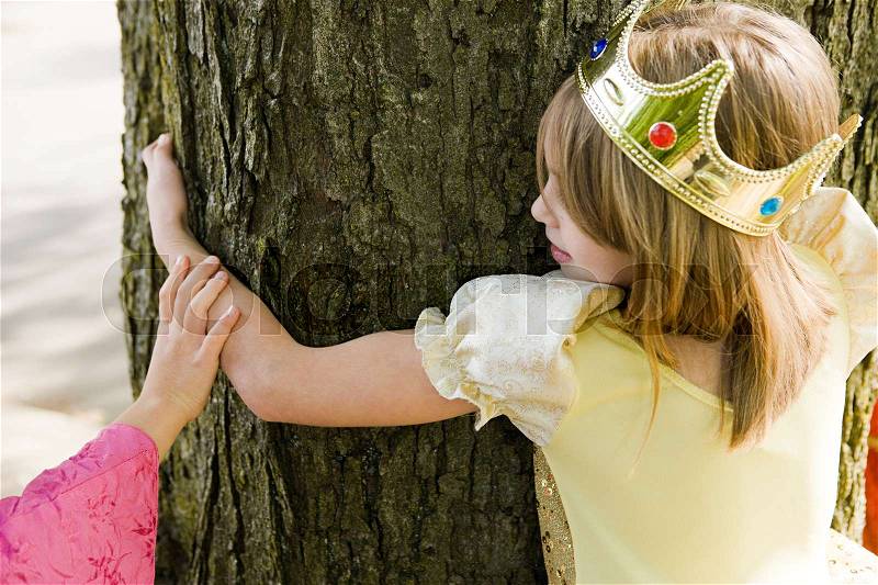 Girl wearing crown dressed up as queen, stock photo