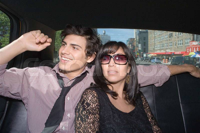 A couple in the back of a taxi, stock photo