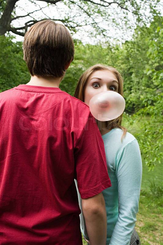 Girl blowing a bubble gum bubble, stock photo