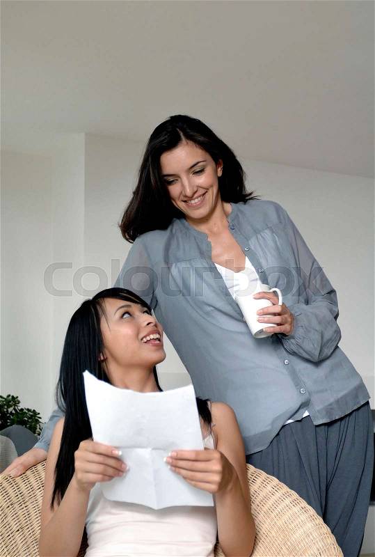 Two women reading a letter, stock photo