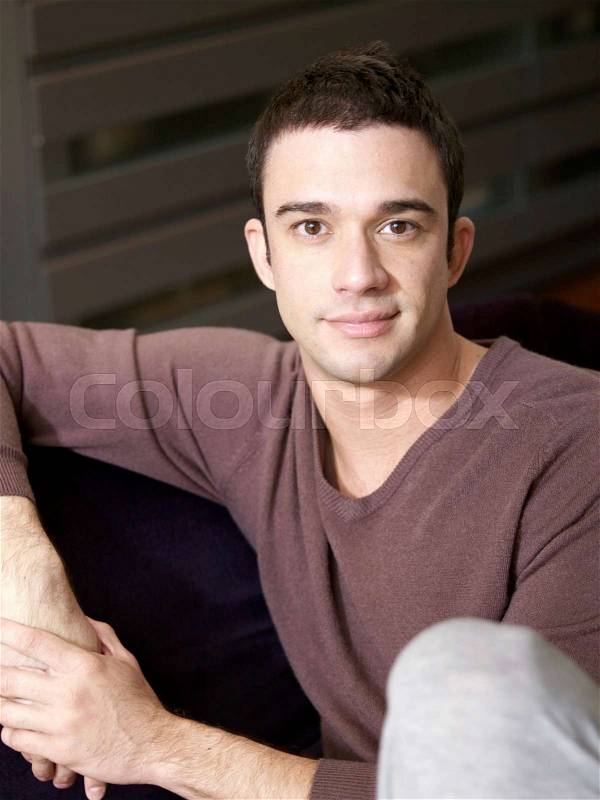 Young man sitting relaxed and casual, stock photo