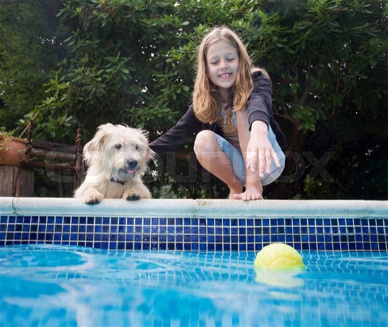 Girl with dog by pool, stock photo