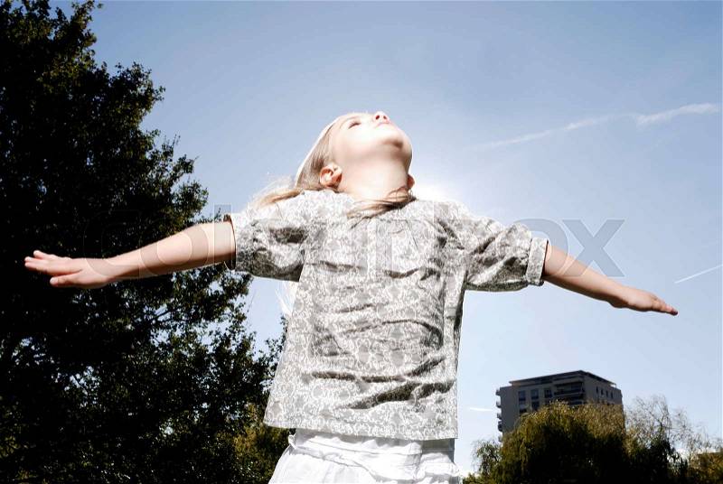 5 years old girl looking at the sky, stock photo
