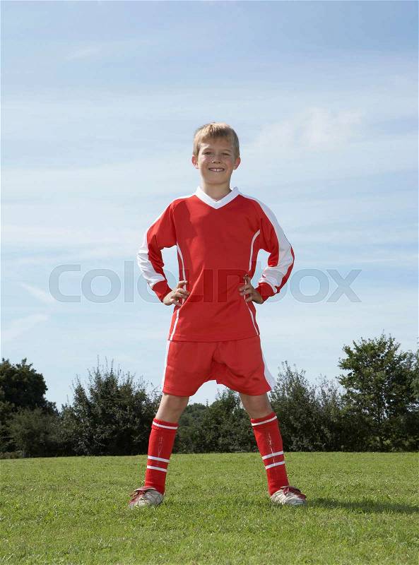 Young Male footballer standing, stock photo