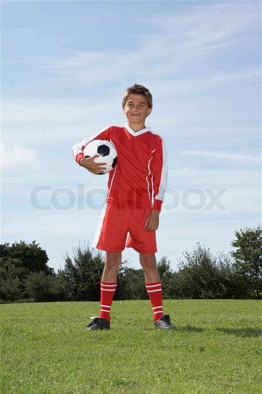 Young Male footballer with a ball, stock photo