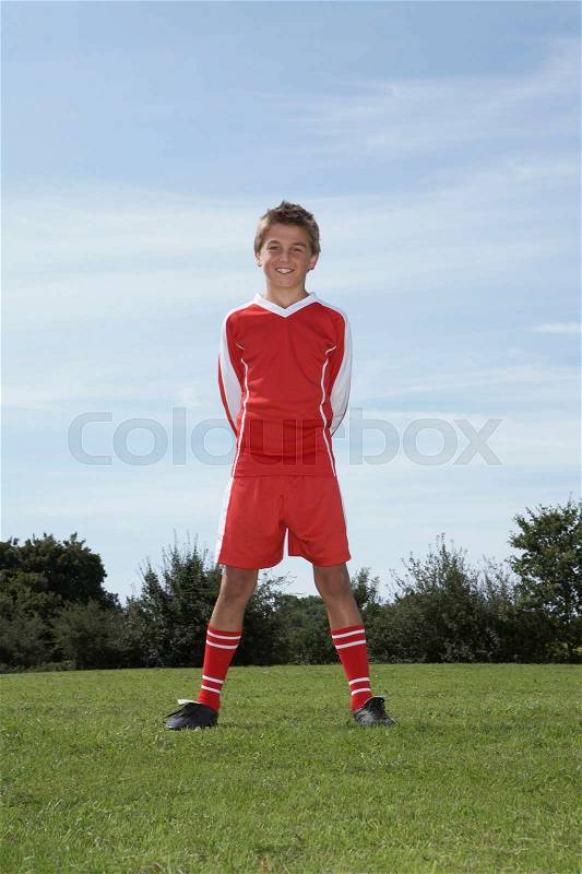 Young Male footballer standing, stock photo