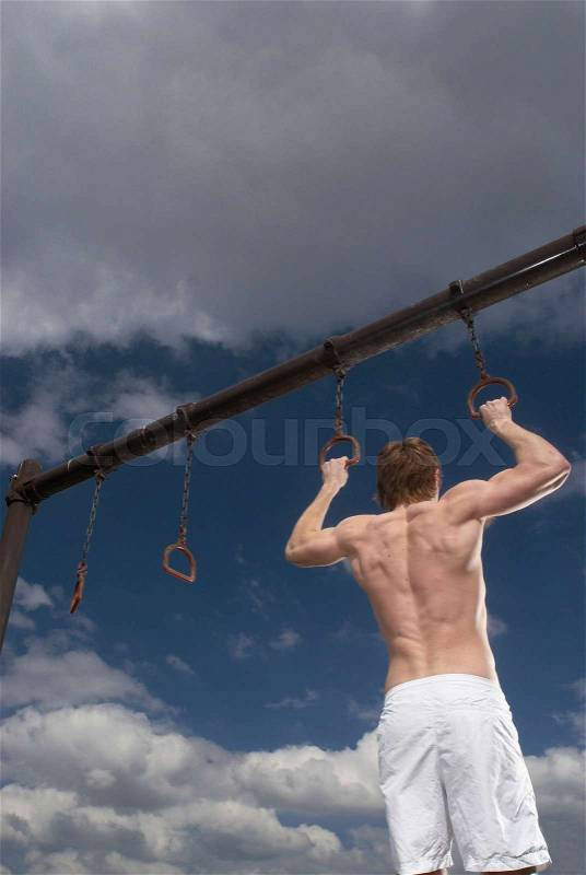 Man holding pull up rings, stock photo