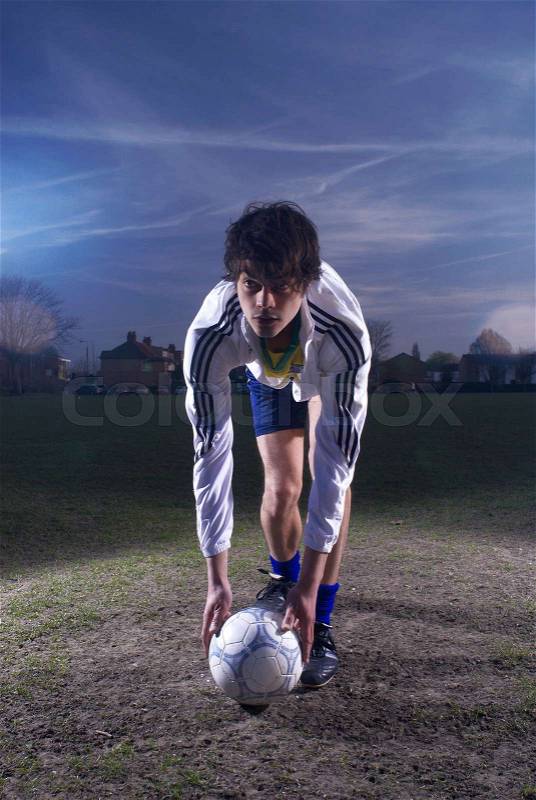 Footballer placing ball, stock photo