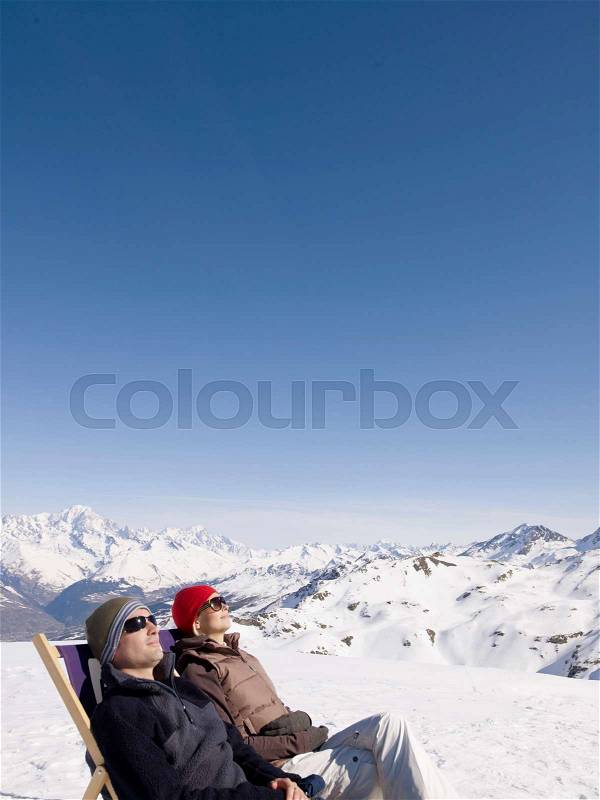 Man and woman on deck chair up mountain, stock photo