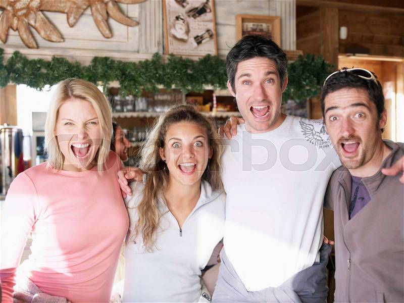 Friends laughing in ski bar, stock photo