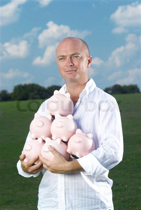 Man holding piggy banks, stock photo