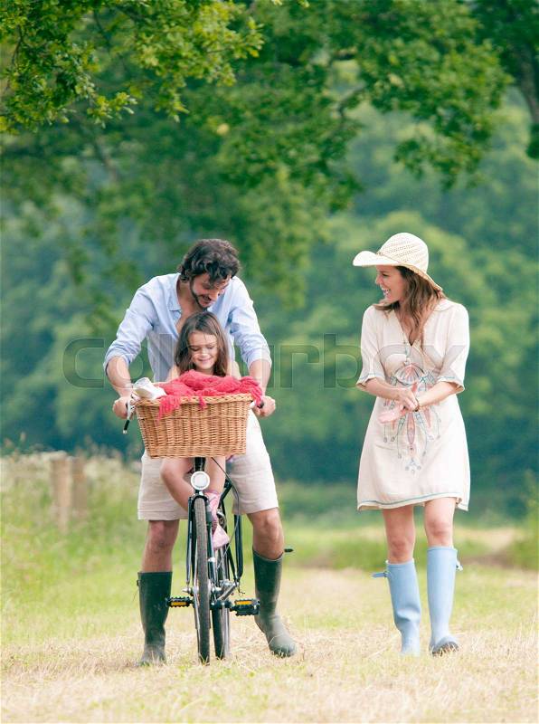 Family walking in country with bike, stock photo
