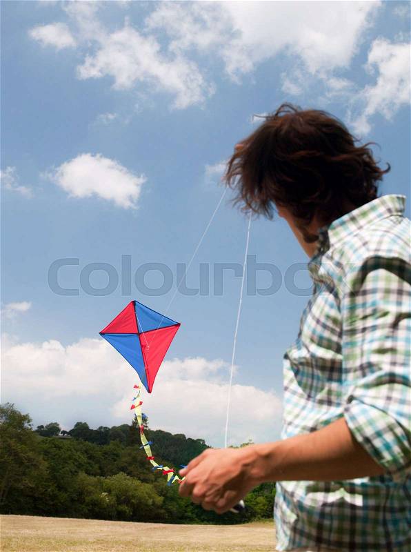 Man flying kite, stock photo