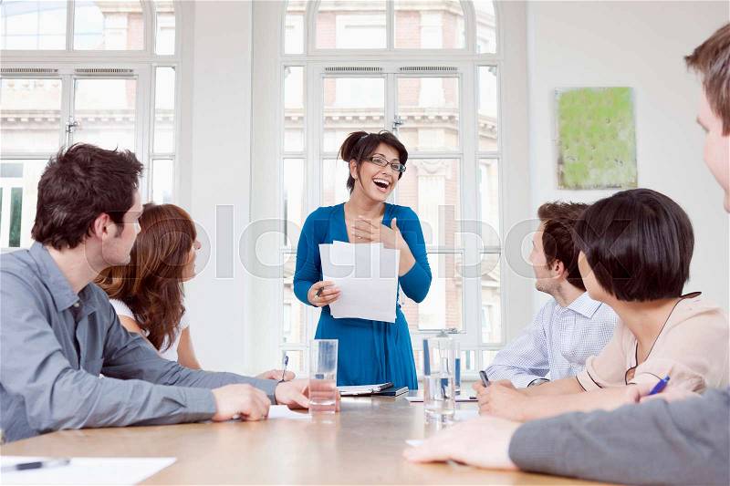 Women talking at conference table, stock photo