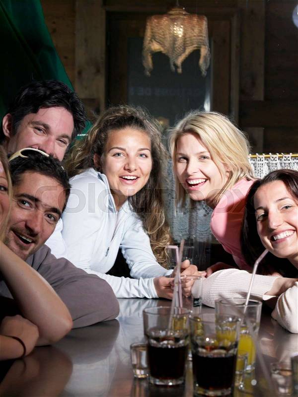 Friends drinking in ski lodge bar, stock photo