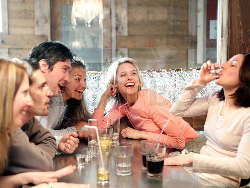 Friends drinking in ski lodge bar, stock photo