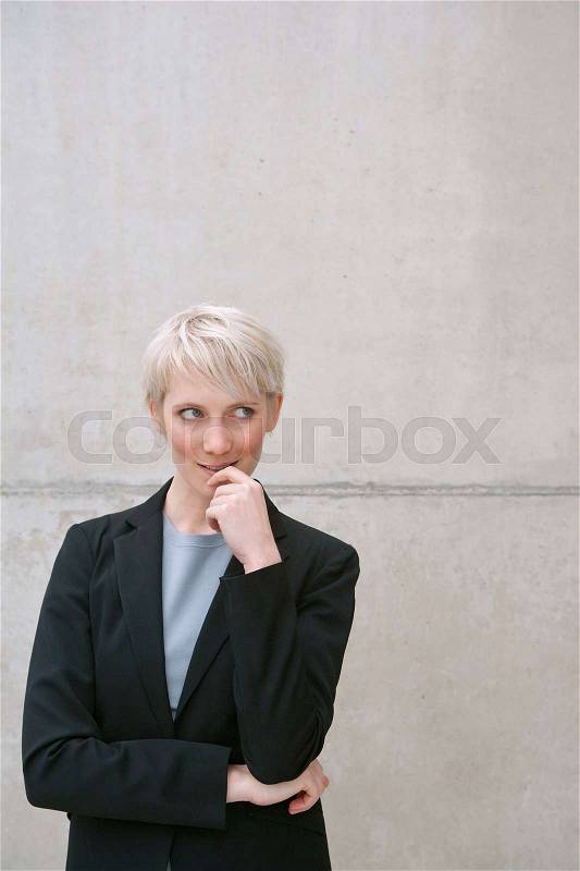 Woman in suit thinking, stock photo