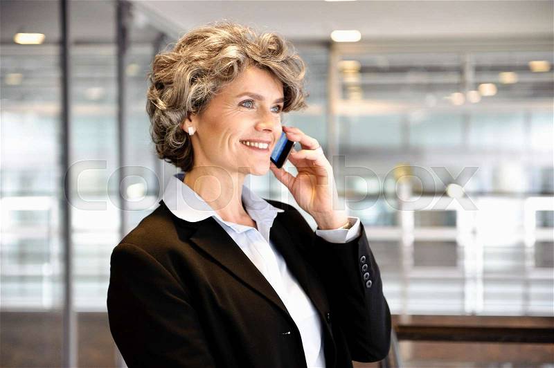 Businesswoman using cell phone, stock photo