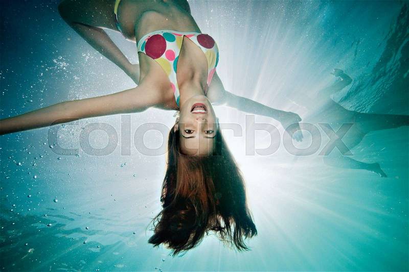 Underwater portrait of female swimmer, stock photo