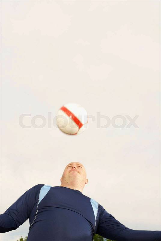 Large footballer heading ball, stock photo