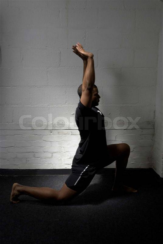 Man lunging in gym, stock photo