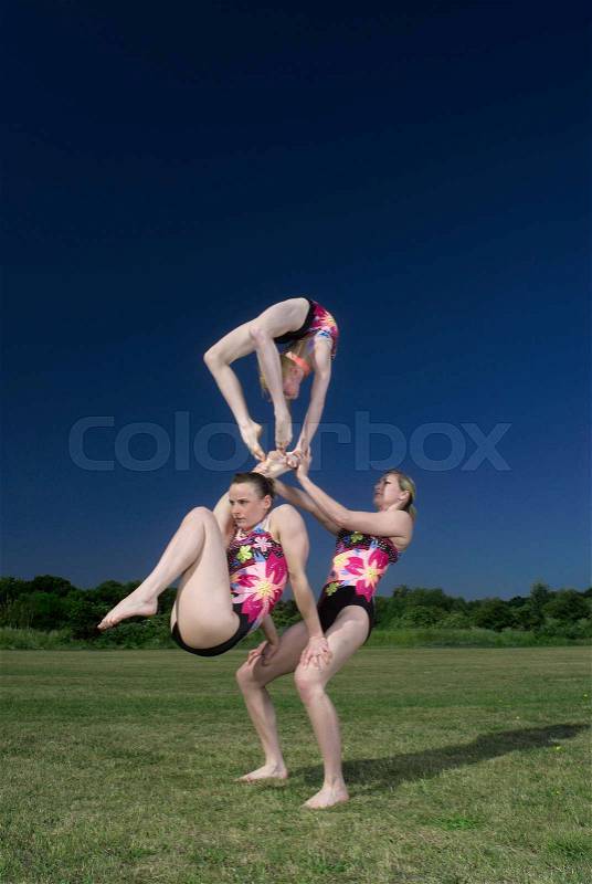 Acrobatic troop performing moves, stock photo