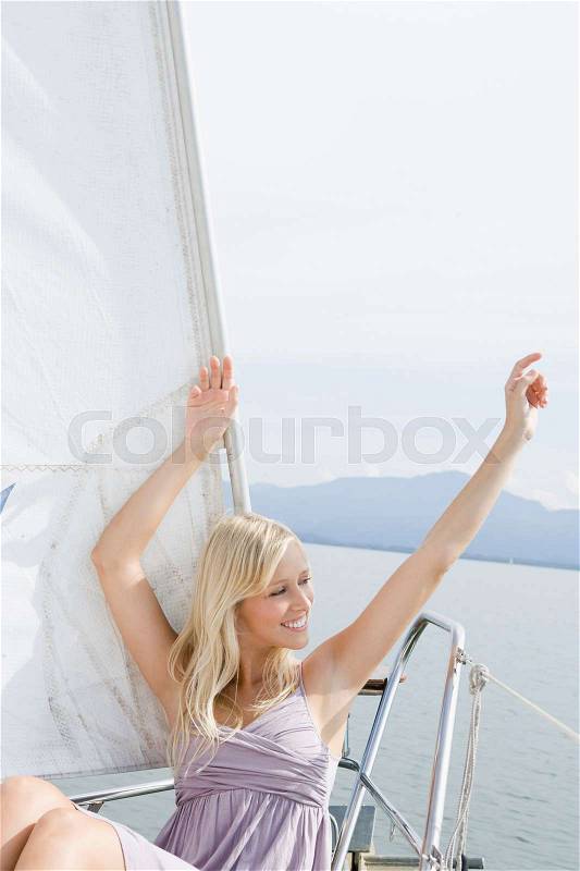 Girl sitting on boat, stock photo