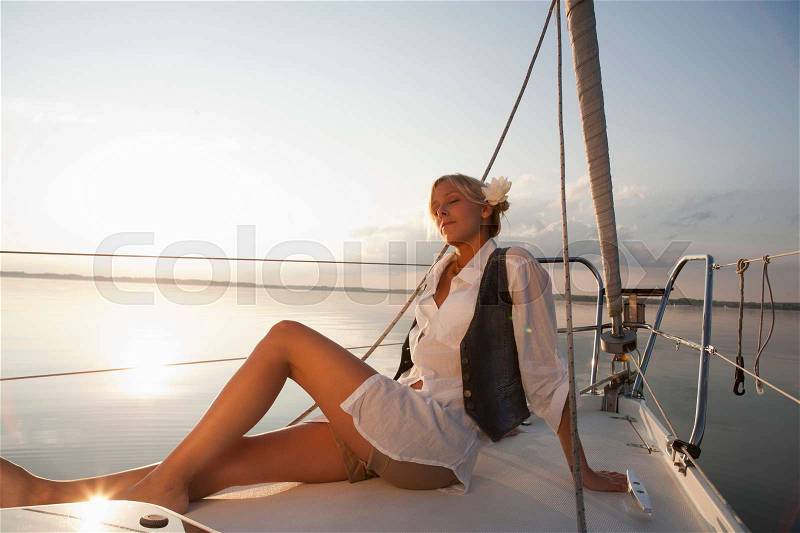 Girl sitting on boat, stock photo