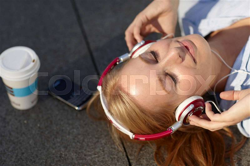 Women with headphone with in lunch break, stock photo