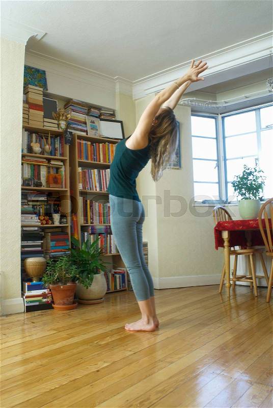 Woman leaning back stretch at home, stock photo