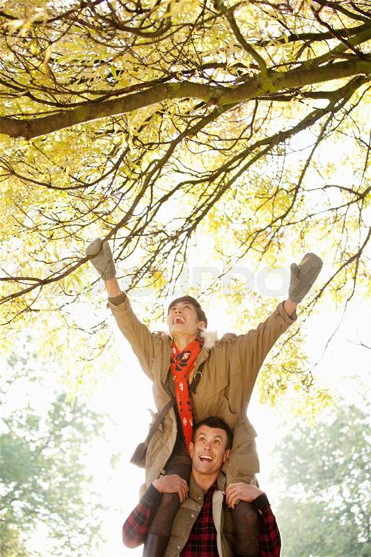 Woman on mans shoulders in the park, stock photo
