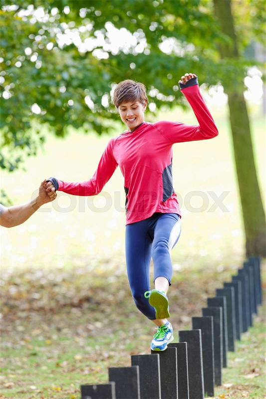 Woman jumping post during workout, stock photo