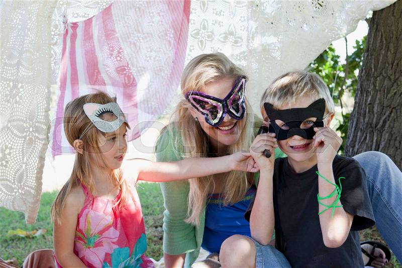 Mother and children wearing masks, stock photo